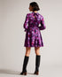 SAMMIEH-Dresses-Hello, gorgeous. SAMMIEH is the ultimate in flirty flower power. Featuring frills, cut outs and a vibrant floral print, this mini dress is just as at home with chunky boots as it is with sky high heels.The fabric of this product is made of 100% recycled polyester. Using recycled polyester helps divert plastic waste from ending in landfills and helps us to reduce our dependancy on virgin materials. Mini dress Floral print Fit and flare Long sleeved with frill cuffs High neck Zip fastening Tie